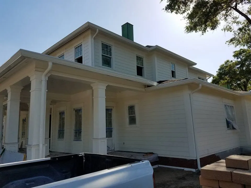Cream lap siding two story wraparound porch columns white gutters, Sanford